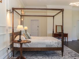 A bedroom with a canopy bed and furniture at Alston Hall near Mothecombe Beach