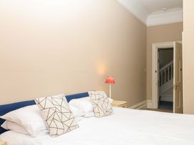 A bedroom with a bed and lamp at Alston Hall near Mothecombe Beach