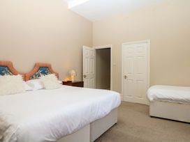 A bedroom with a bed and a nightstand at Alston Hall near Mothecombe Beach