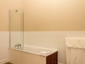 A bathroom with a bathtub and a towel at Alston Hall near Mothecombe Beach