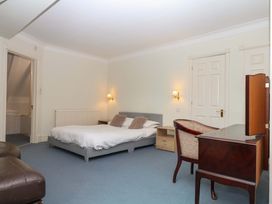 A bedroom with a bed and desk at Alston Hall near Mothecombe Beach