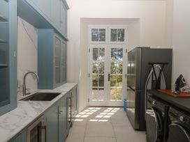 A kitchen with a sink and refrigerator at Alston Hall near Mothecombe Beach