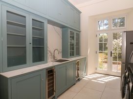 A kitchen with cabinets and a sink at Alston Hall near Mothecombe Beach