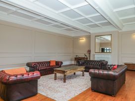 A living room with sofas and a coffee table at Alston Hall near Mothecombe Beach
