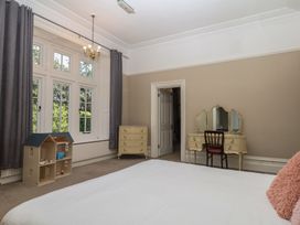 A bedroom with bed and furniture at Alston Hall near Mothecombe Beach