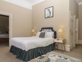 A bedroom with a bed and bedside table at Alston Hall near Mothecombe Beach