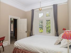 A bedroom with a bed and a lamp at Alston Hall near Mothecombe Beach