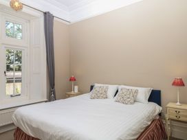 A bedroom with a bed and side tables at Alston Hall near Mothecombe Beach