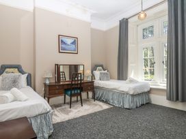 A bedroom with two beds and a desk at Alston Hall near Mothecombe Beach
