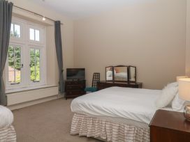 A bedroom with two beds and a television at Alston Hall near Mothecombe Beach