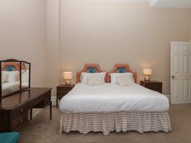 A bedroom with a double bed and a mirror at Alston Hall near Mothecombe Beach