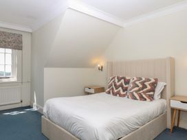 A bedroom with a bed and bedside table at Alston Hall near Mothecombe Beach
