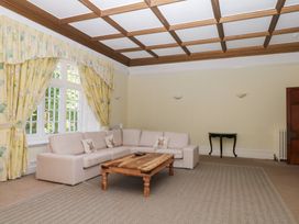 A living room with a sofa and coffee table at Alston Hall near Mothecombe Beach