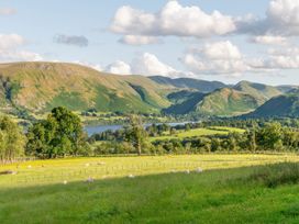 A landscape view of mountains and a lake with sheep grazing at Bank Barn, Wreay in Watermillock