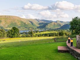 A view of hills and a lake with trees and grass at Bank Barn, Wreay in Watermillock
