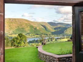 A view of mountains and a lake from a stone wall at Bank Barn, Wreay Watermillock