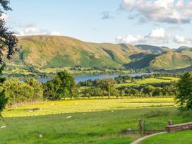 A landscape view featuring mountains, a lake, and sheep at Bank Barn, Wreay Watermillock