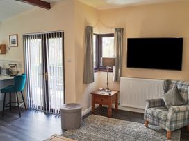 A living room with a television and sofa at Cowslip in Saltburn-By-The-Sea