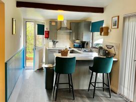 A kitchen featuring a countertop and bar stools at Cowslip in Saltburn-By-The-Sea