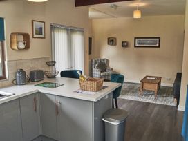 A kitchen with a sink and table at Cowslip in Saltburn-By-The-Sea