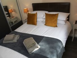 A bedroom with a bed and pillows at Cowslip in Saltburn-By-The-Sea