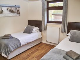 A bedroom with two single beds and a window at Cowslip in Saltburn-By-The-Sea