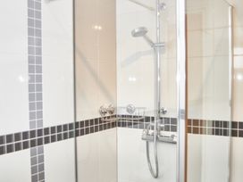 A shower with glass enclosure and tiles at Cowslip in Saltburn-By-The-Sea