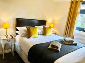 A bedroom with a bed and bedside table at Cowslip in Saltburn-By-The-Sea