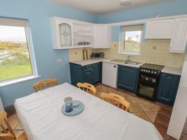 A kitchen with a table and chairs at No.5 Beach Cottages in Keel, County Mayo