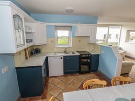A kitchen with cabinets and appliances at No.5 Beach Cottages Keel, County Mayo