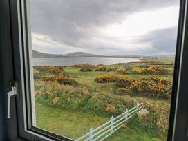 A view of landscape with water and greenery from a window at No.5 Beach Cottages in Keel, County Mayo