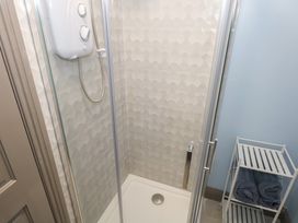A shower with a control unit and towels in a bathroom at No.5 Beach Cottages, Keel, County Mayo