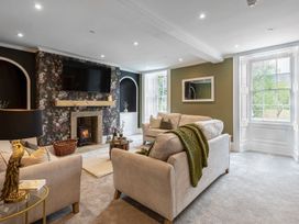 A living room with a fireplace and a television at Snowdonia Manor in Dolgellau