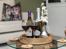 A living room with wine glasses and a flower vase at Snowdonia Manor in Dolgellau