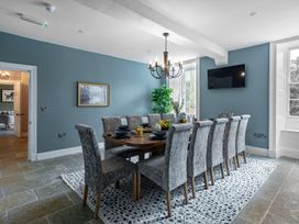 A dining room with a large table and chairs at Snowdonia Manor in Dolgellau
