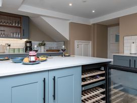 A kitchen with wine glasses and food on a countertop at Snowdonia Manor in Dolgellau
