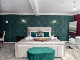 A bedroom with a bed and nightstand at Snowdonia Manor, Dolgellau