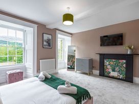 A bedroom with a bed and furniture at Snowdonia Manor in Dolgellau