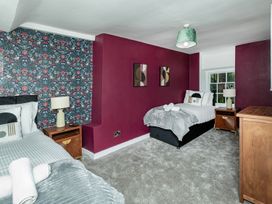 A bedroom with two beds and artwork on the walls at Snowdonia Manor in Dolgellau