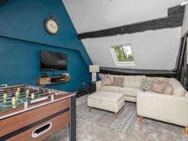 A snug with a foosball table and a sofa at Snowdonia Manor in Dolgellau