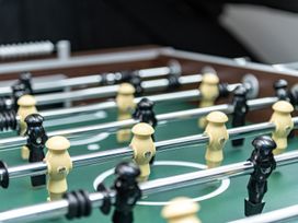 A foosball table with black and yellow players at Snowdonia Manor in Dolgellau