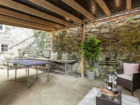 An outdoor seating area with a table and bench at Snowdonia Manor in Dolgellau