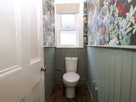 A bathroom with a toilet and window at Curzon Heights in Llandudno