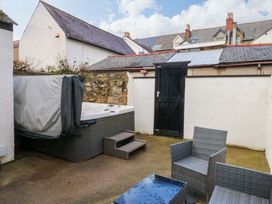 An outdoor space with a hot tub and seating area at Curzon Heights in Llandudno
