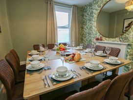 A dining room with a table and chairs at Curzon Heights in Llandudno