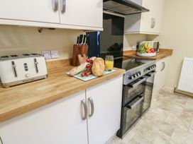 A kitchen with a toaster and oven at Curzon Heights in Llandudno