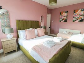 A bedroom with a bed and nightstand at Curzon Heights in Llandudno