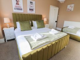 A bedroom with a double bed and two bedside tables at Curzon Heights Llandudno
