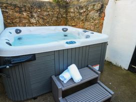 A hot tub with towels and steps in an outdoor area at Curzon Heights in Llandudno