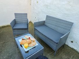 An outdoor seating area with a sofa, chair, and table at Curzon Heights in Llandudno